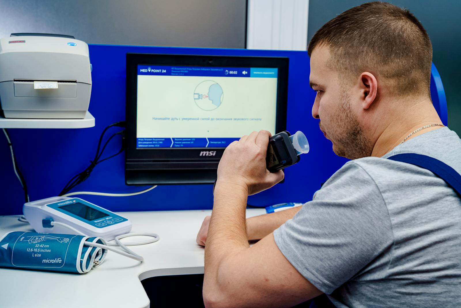 Patient performing a spirometry breathing test during pulmonary function testing